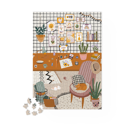 Puzzle L’Atelier en cours d’assemblage sur une table. Pièces du cadre déjà posées.