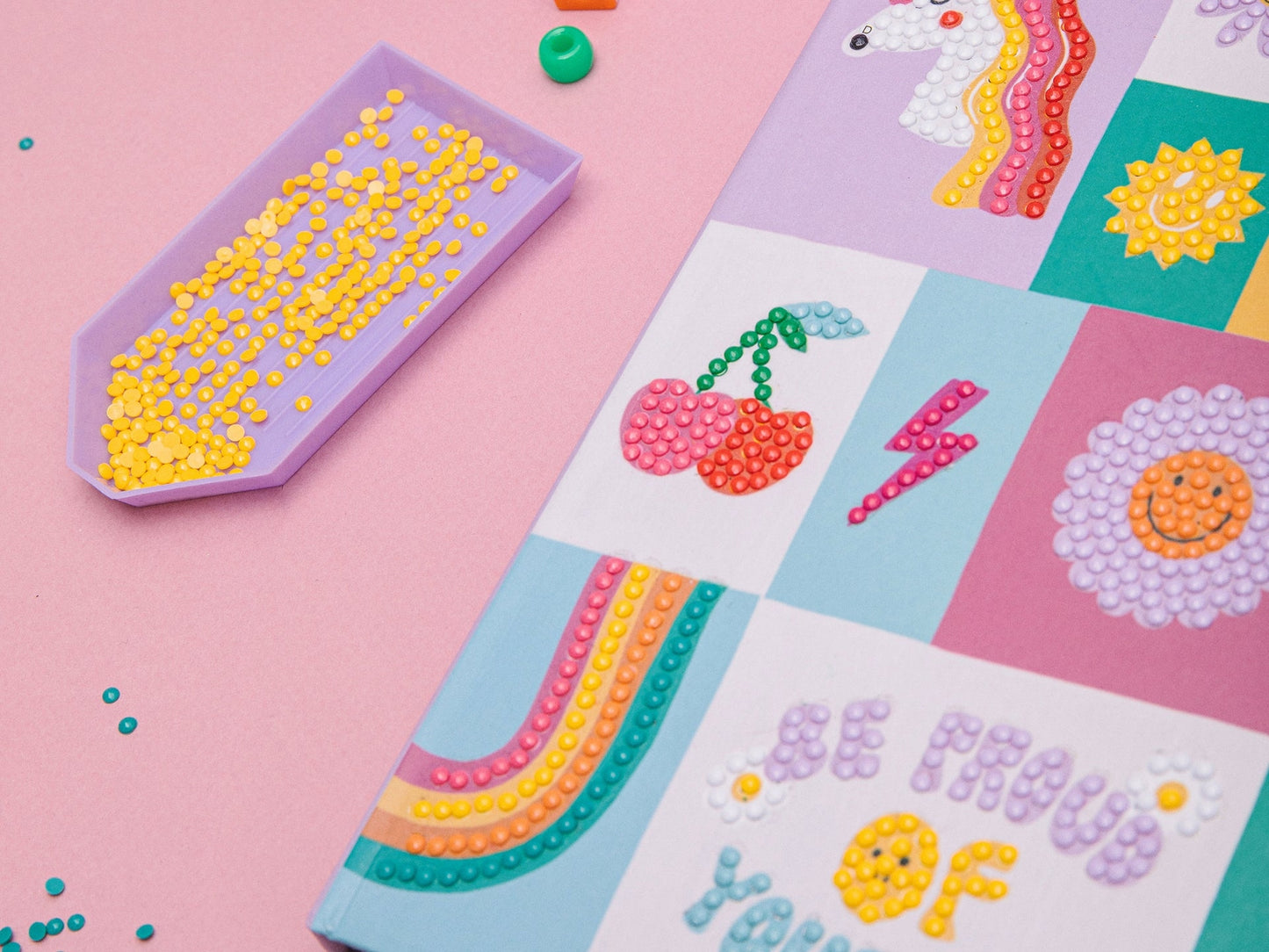 Enfant décorant son carnet secret avec des strass brillants.